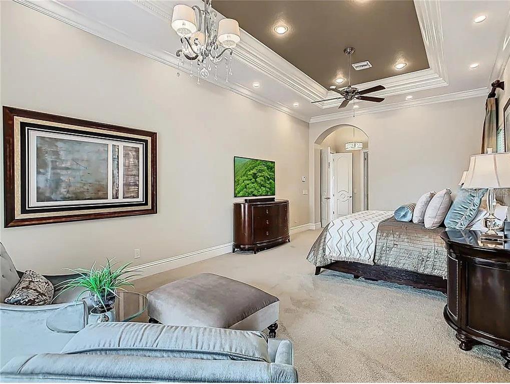 395 Muirfield Loop Reunion, FL 34747 - Photo 36 of 50 a bedroom with a bed and ceiling fan