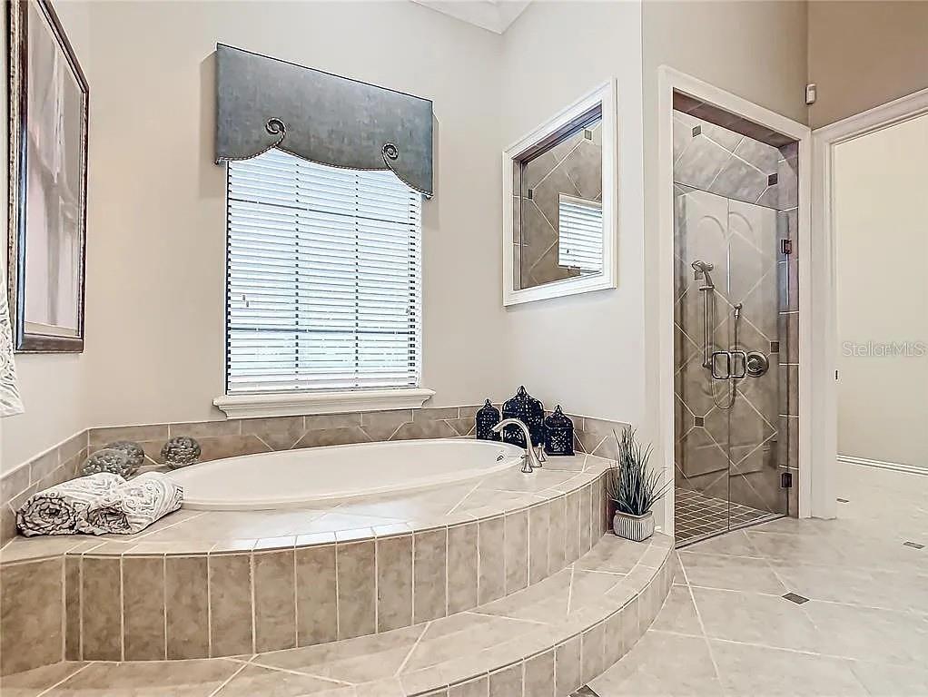 395 Muirfield Loop Reunion, FL 34747 - Photo 40 of 50 a bathroom with a tub sink and shower