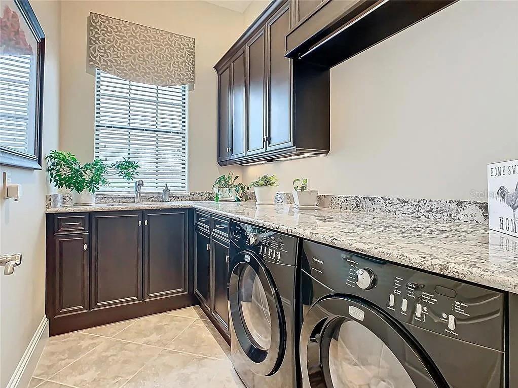 395 Muirfield Loop Reunion, FL 34747 - Photo 41 of 50 a bathroom with a granite countertop sink and a mirror