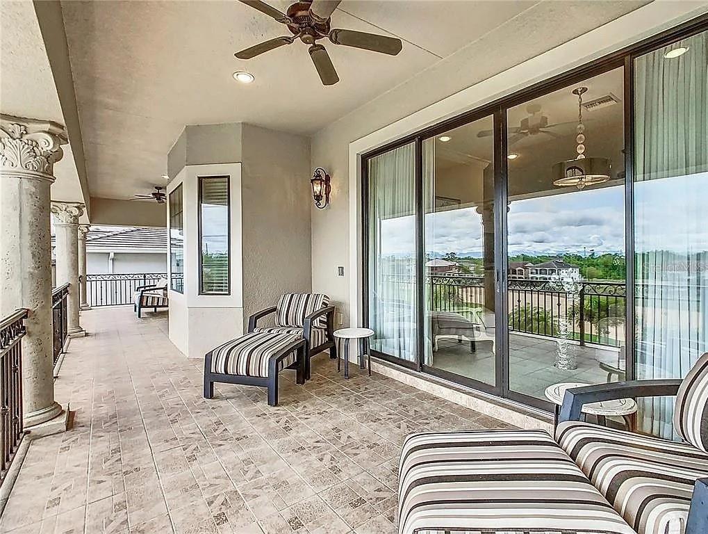 395 Muirfield Loop Reunion, FL 34747 - Photo 42 of 50 a view of a livingroom with furniture and floor to ceiling window