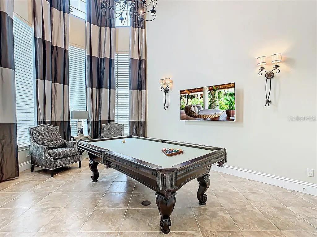 395 Muirfield Loop Reunion, FL 34747 - Photo 5 of 50 a room with furniture pool table and windows