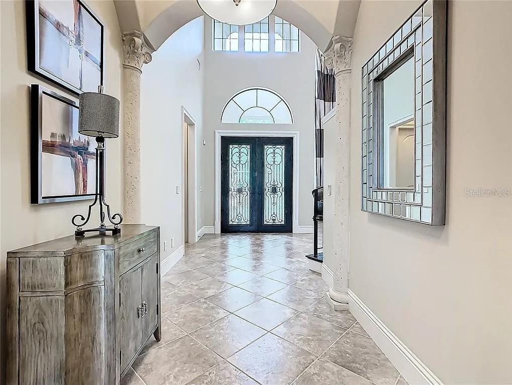 395 Muirfield Loop Reunion, FL 34747 - Photo 6 of 50 a view of a hallway with a chandelier