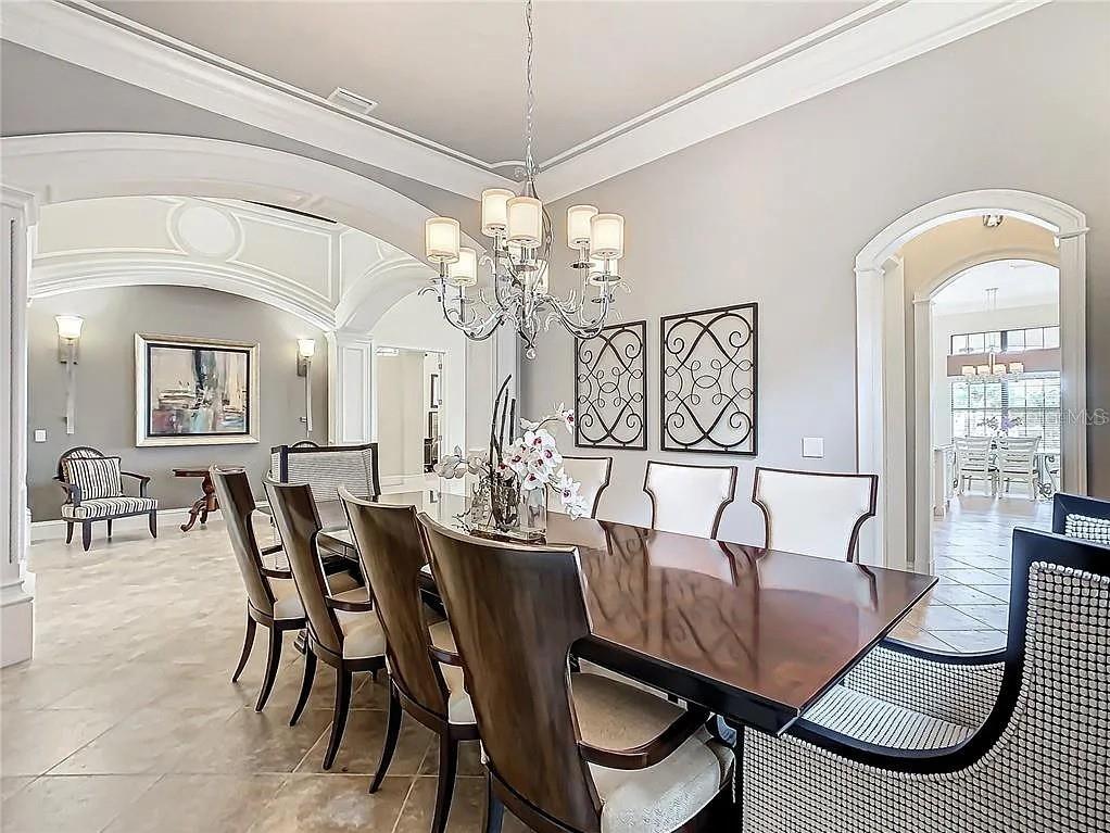 395 Muirfield Loop Reunion, FL 34747 - Photo 8 of 50 a view of a dining room with furniture and chandelier