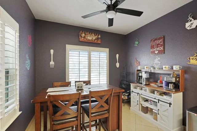 a view of a dining room with furniture and a window