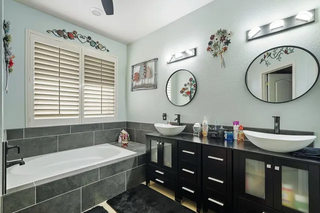 a bathroom with a double vanity sink and a mirror