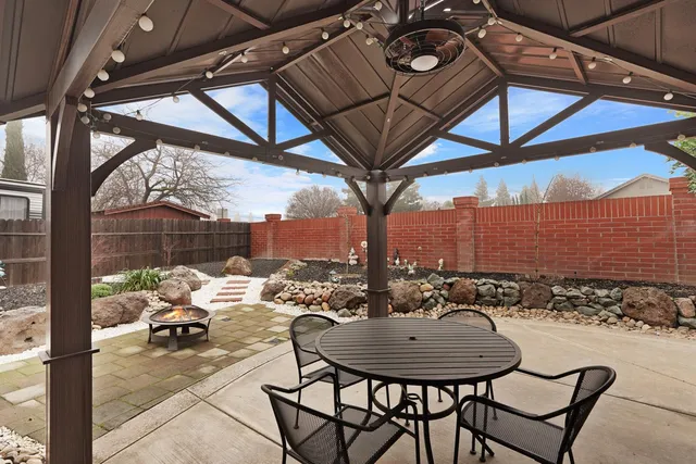 a view of a roof deck with table and chairs and potted plants