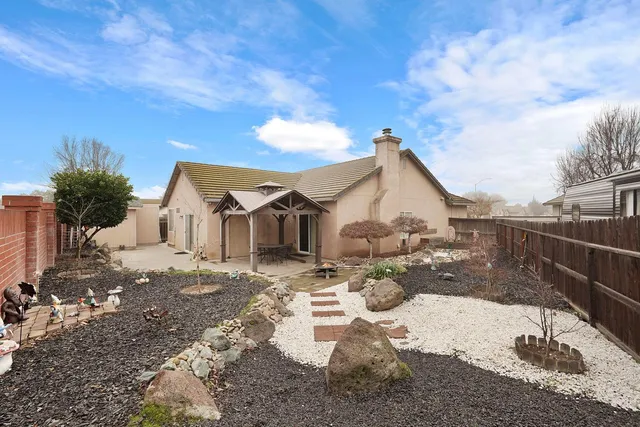 a view of a backyard with sitting area