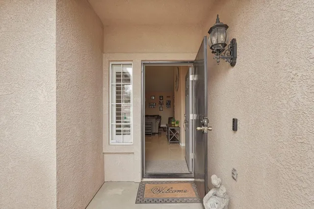 a view of a hallway with closet and a living room