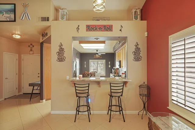 a kitchen with a dining table chairs and window