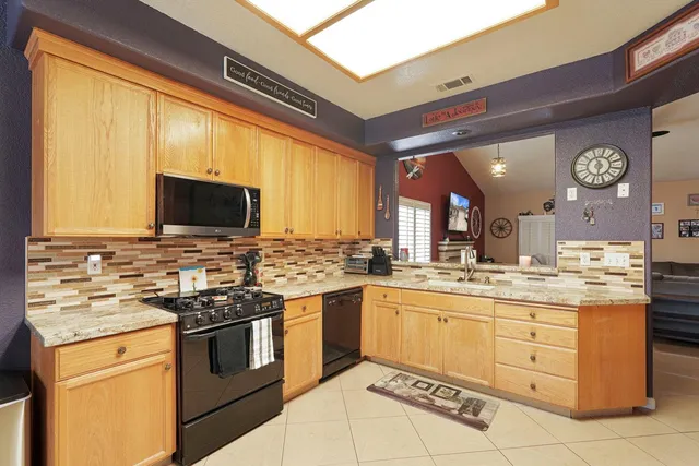 a kitchen with a stove a sink and a microwave