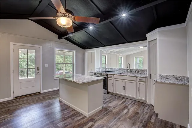 a kitchen with stainless steel appliances granite countertop a stove a sink dishwasher and a refrigerator