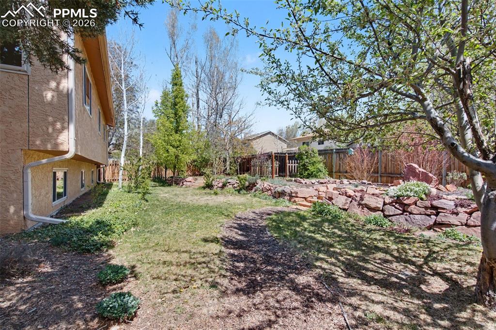 5301 Pinon Valley Road Colorado Springs, CO 80919 - Photo 22 of 27 a backyard of a house with lots of green space