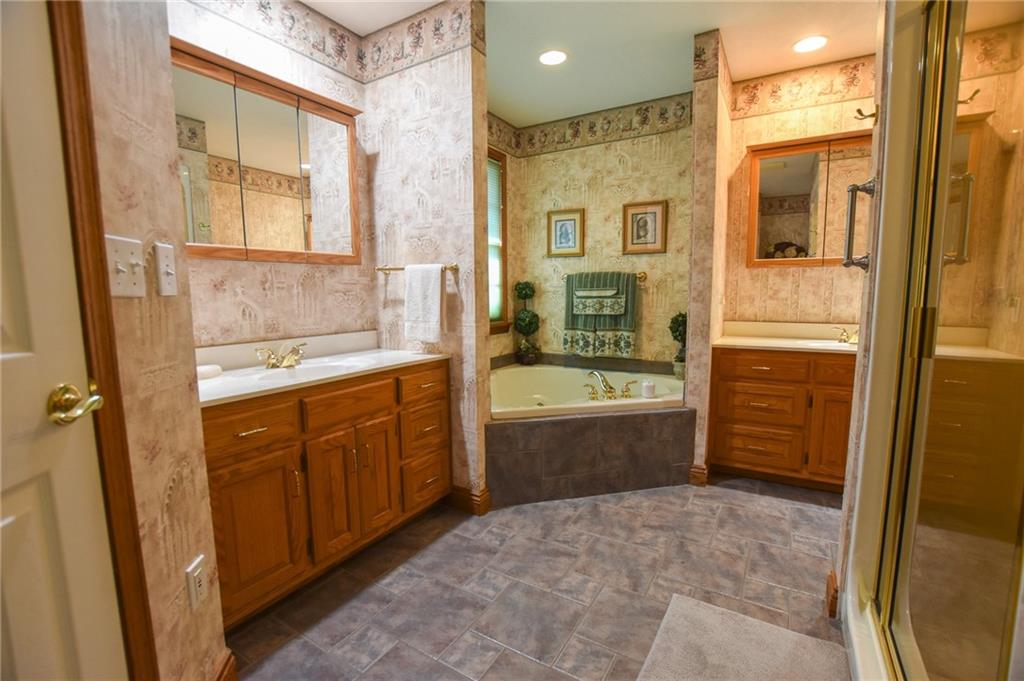 115 Shepperd Drive Butler, PA 16002 - Photo 15 of 24 a spacious bathroom with a granite countertop sink a mirror a bathtub and shower