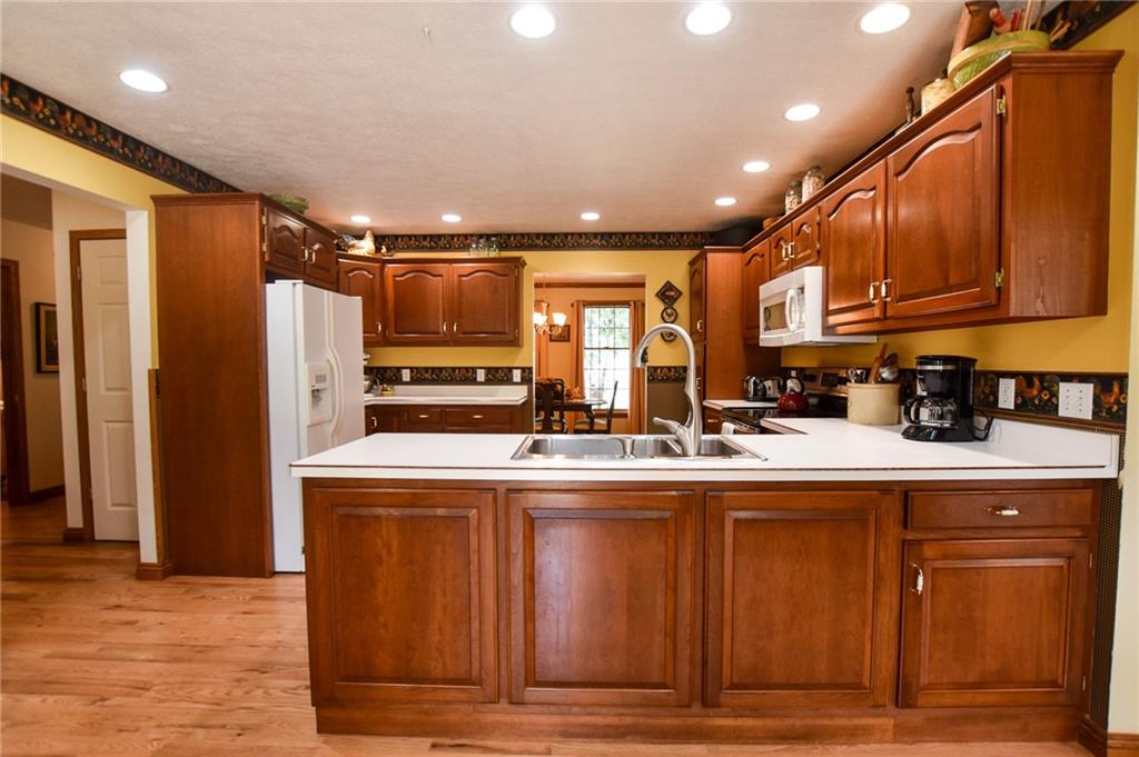 115 Shepperd Drive Butler, PA 16002 - Photo 4 of 24 a kitchen with kitchen island granite countertop wooden cabinets and refrigerator