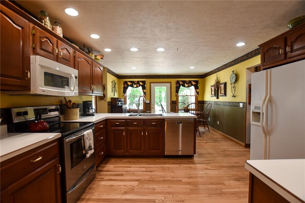 115 Shepperd Drive Butler, PA 16002 - Photo 5 of 24 a large kitchen with stainless steel appliances granite countertop a stove a sink dishwasher a refrigerator and a microwave