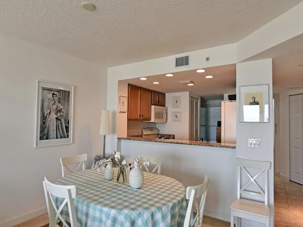 a kitchen with stainless steel appliances granite countertop a refrigerator stove and oven