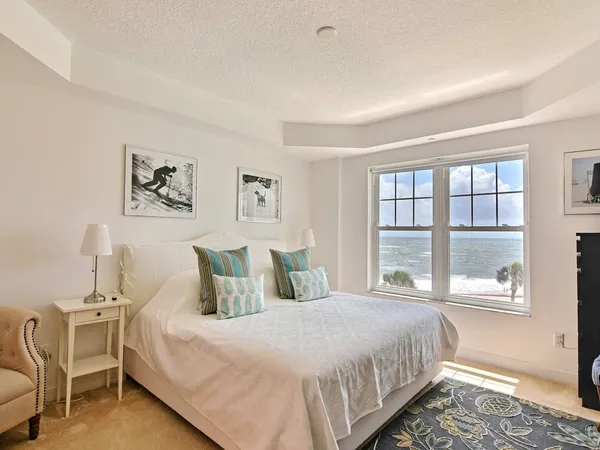 a bedroom with a bed window and table