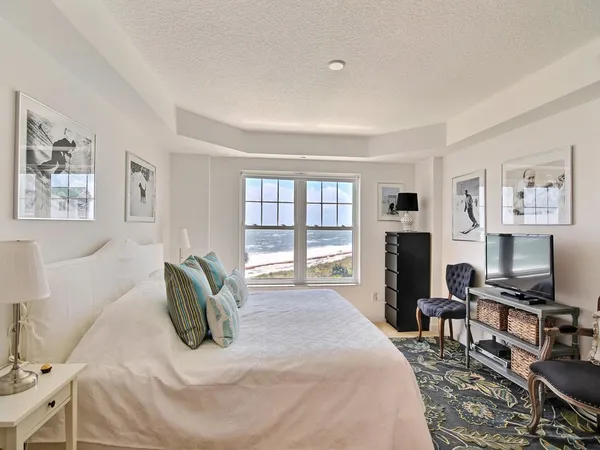 a bedroom with furniture a flat screen tv and a fireplace