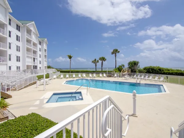 a swimming pool with outdoor seating and yard