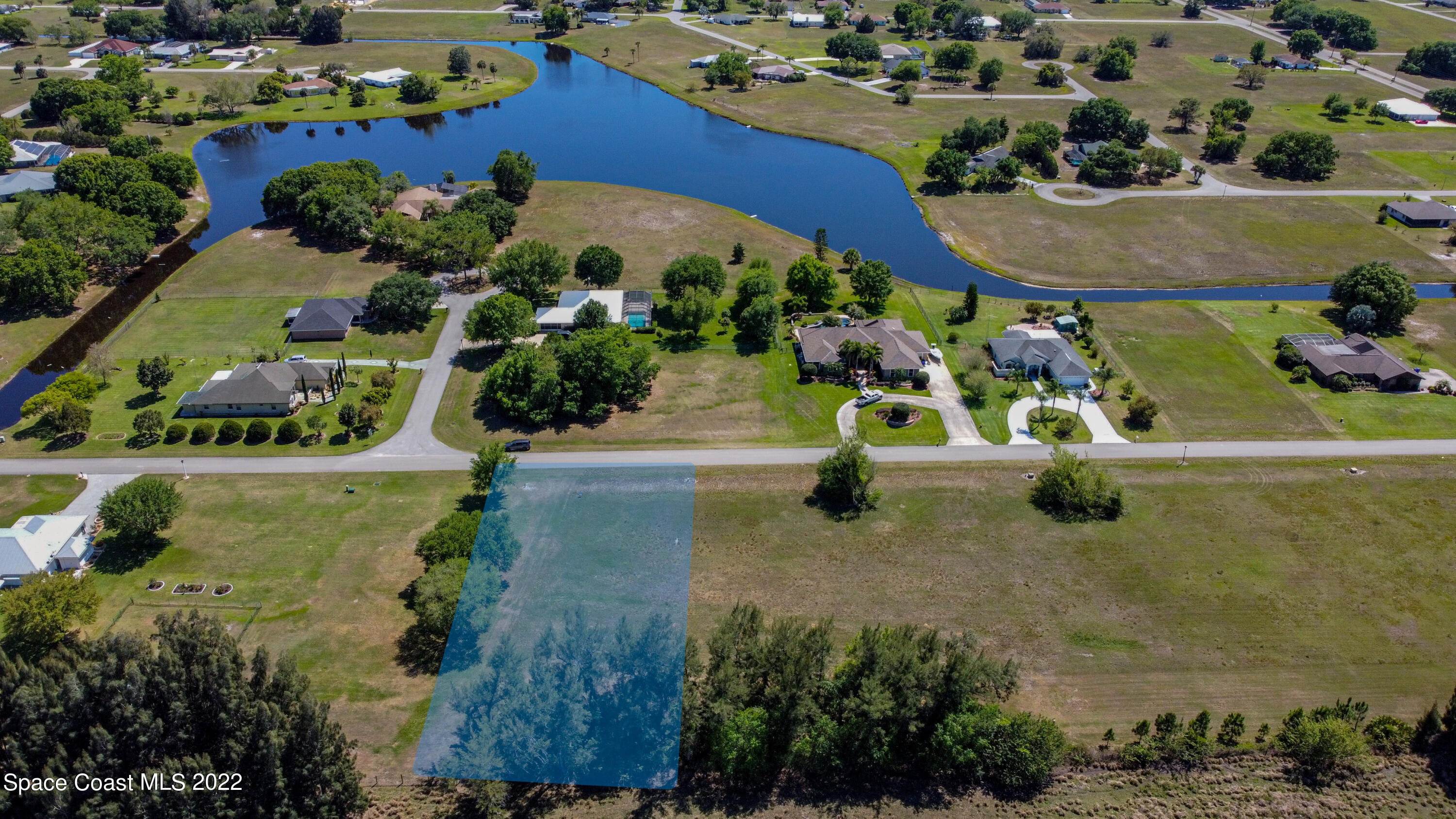 8301 Castile Road Sebring, FL 33876 - Photo 3 of 25 an aerial view of a house with a yard and lake view