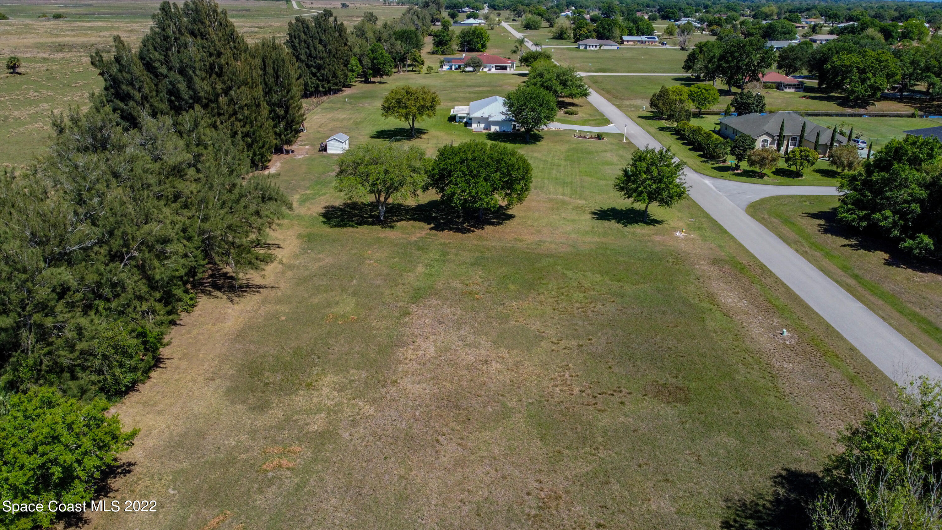8301 Castile Road Sebring, FL 33876 - Photo 4 of 25 an aerial view of a house with a yard and lake view