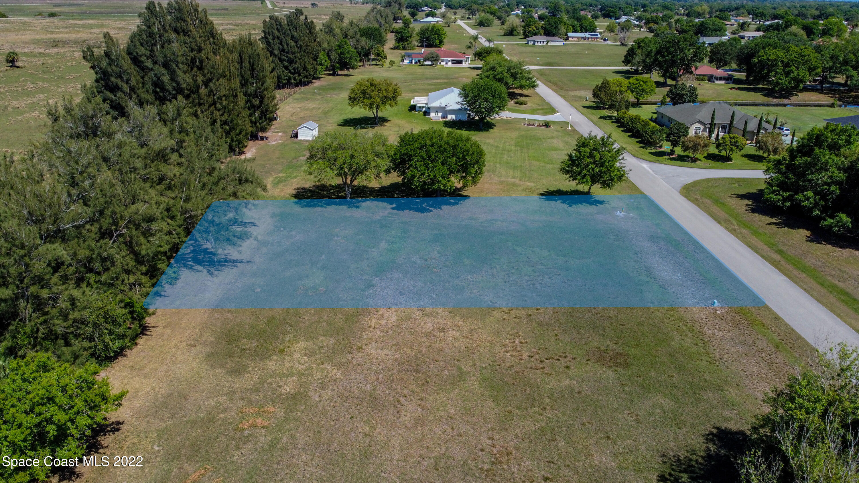 8301 Castile Road Sebring, FL 33876 - Photo 5 of 25 an aerial view of a house with a yard and lake view