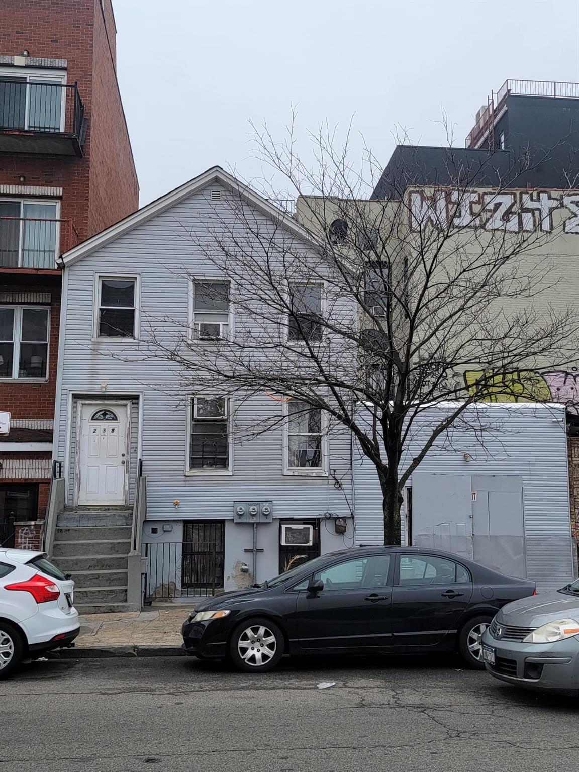 a couple of cars parked in front of a house