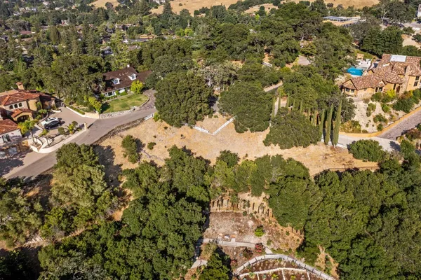 an aerial view of a house with a yard