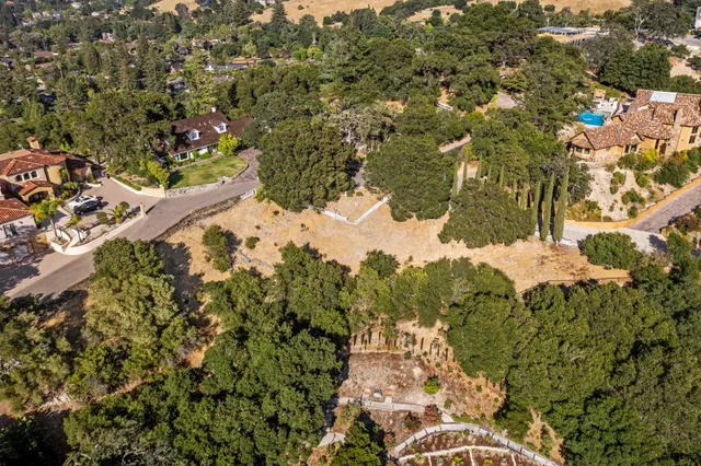 an aerial view of a house with a yard