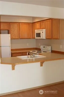 a kitchen with stainless steel appliances granite countertop a sink and a microwave