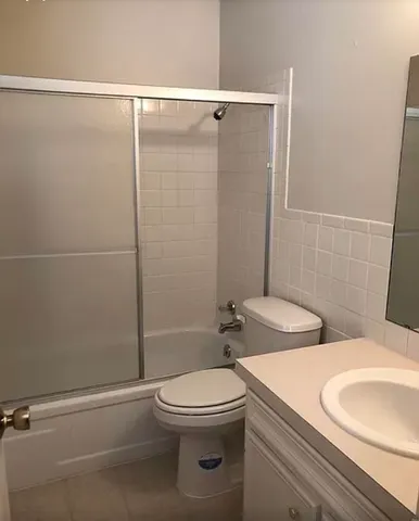 a bathroom with a toilet a sink and shower