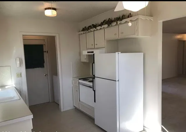 a white refrigerator freezer and a dishwasher sitting in a kitchen