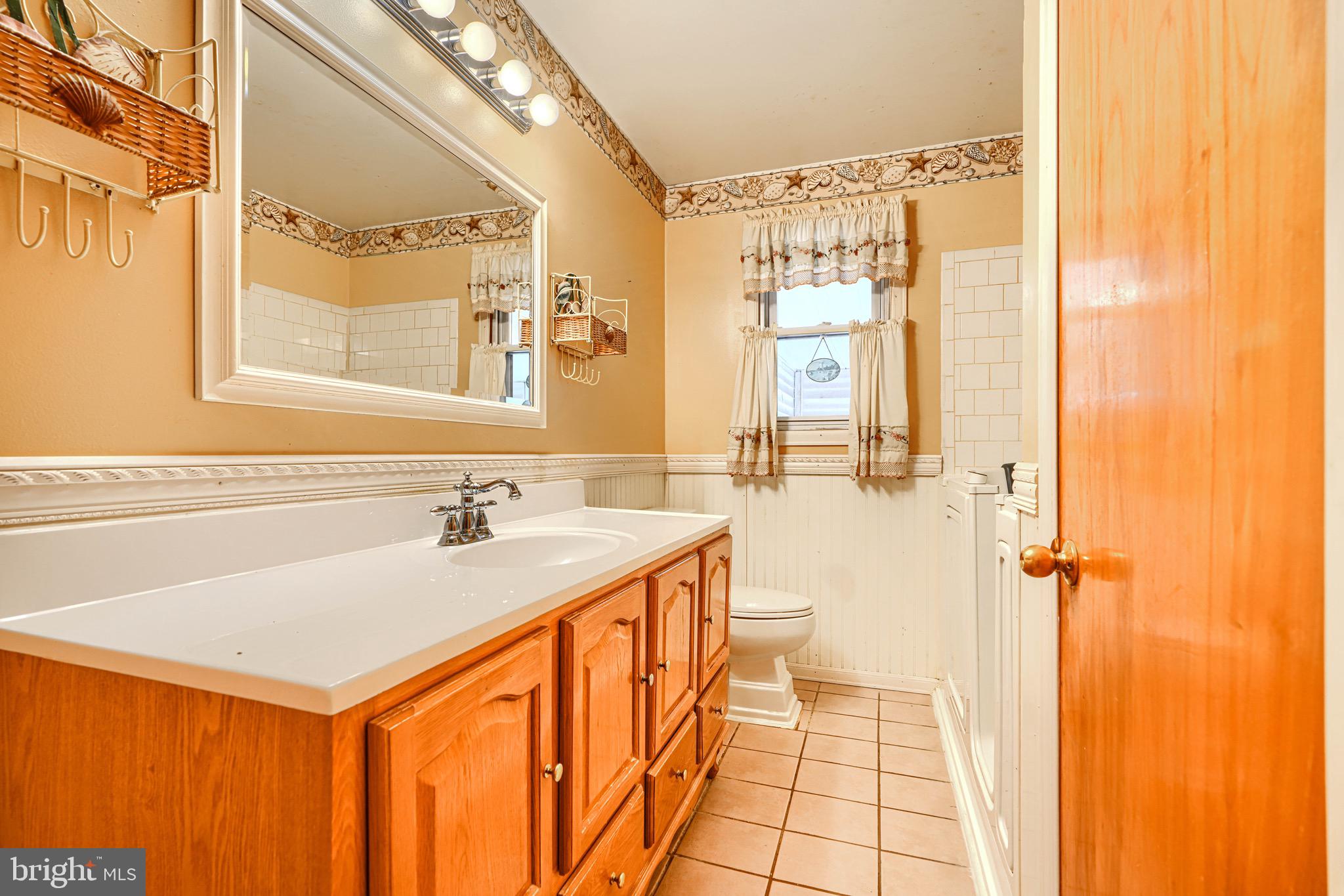 3118 Lynch Road Sparrows Point, MD 21219 - Photo 39 of 46 a bathroom with a sink a mirror and a shower
