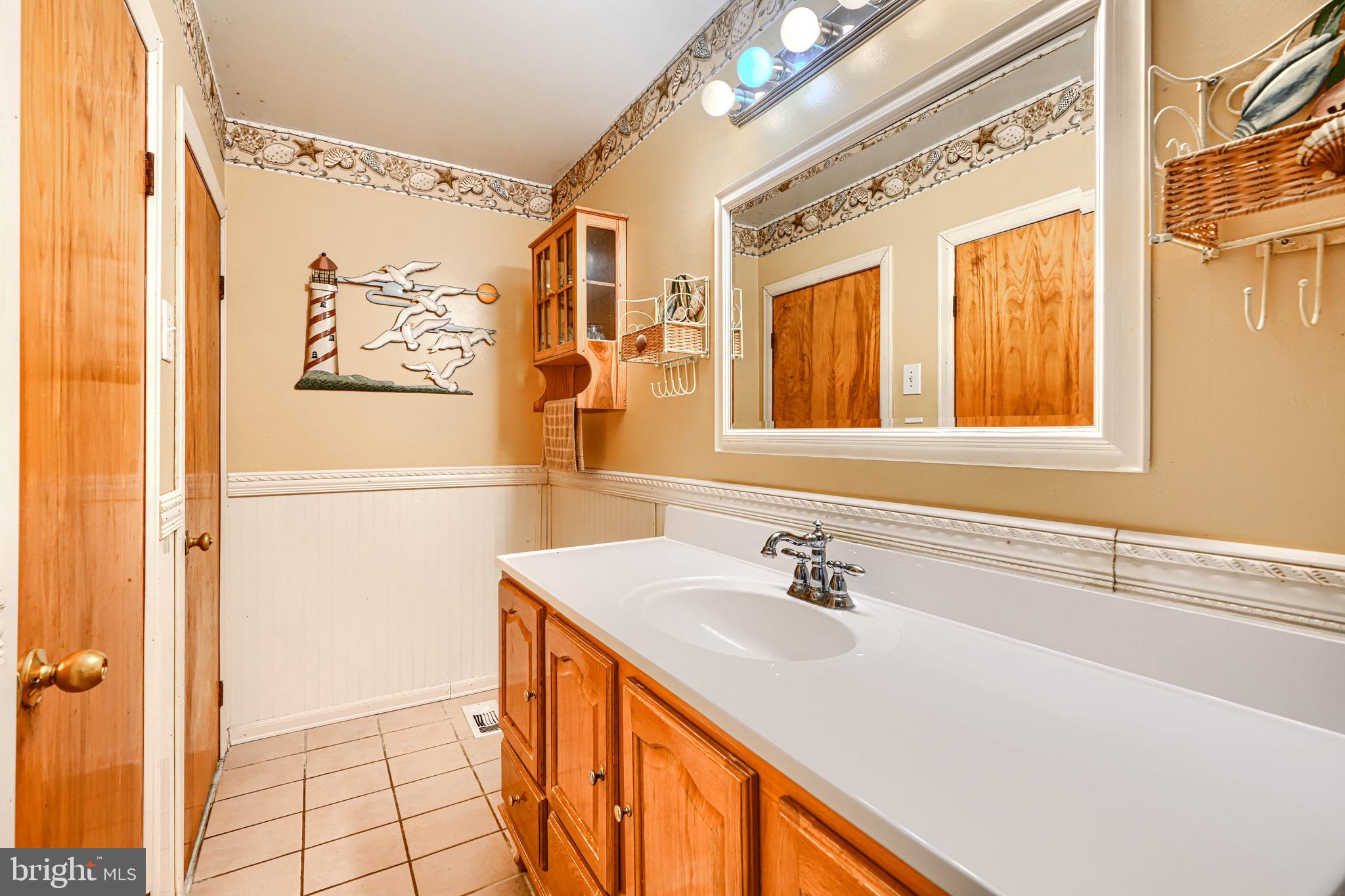 3118 Lynch Road Sparrows Point, MD 21219 - Photo 42 of 46 a bathroom with a sink and a mirror