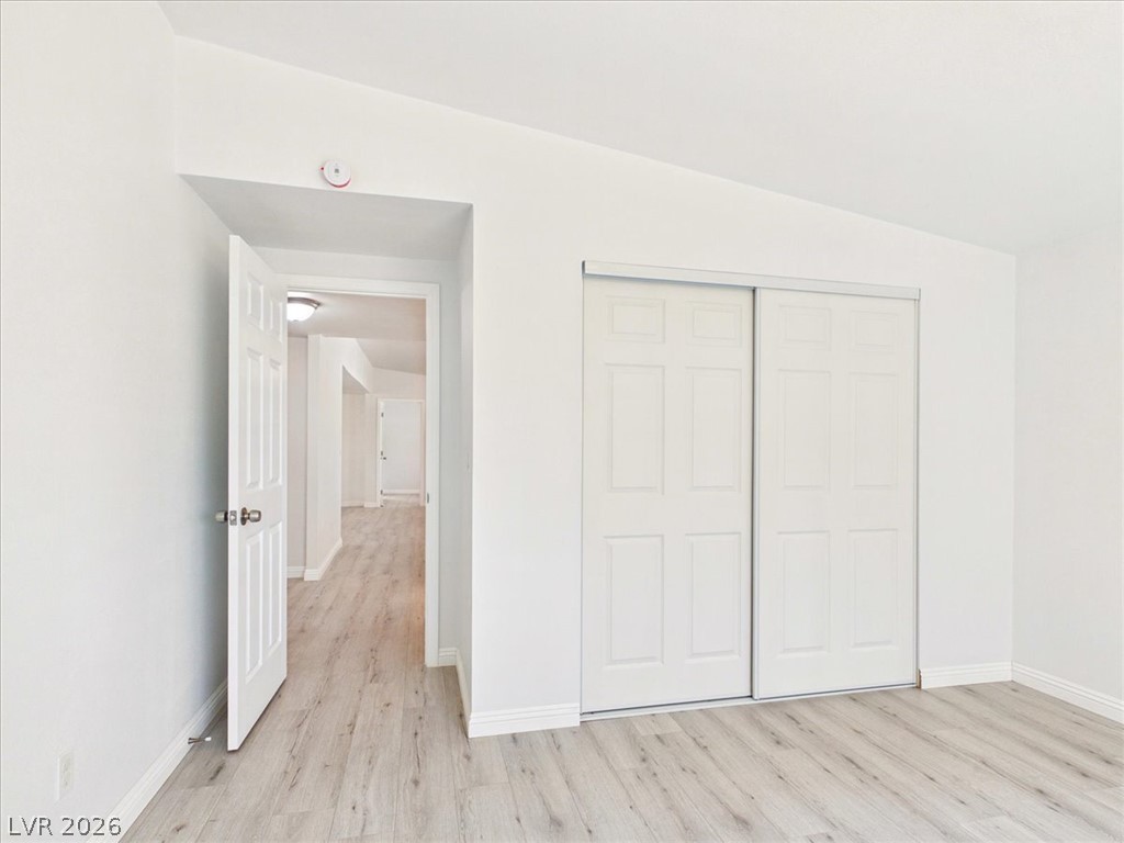 4081 Retread Road Pahrump, NV 89048 - Photo 48 of 98 A quiet, well-lit bedroom features contemporary wood flooring and practical sliding closet doors.