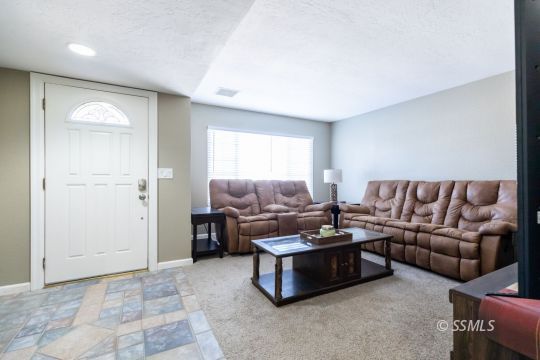 609 South Gemstone Street Ridgecrest, CA 93555 - Photo 6 of 35 a living room with furniture and a couch