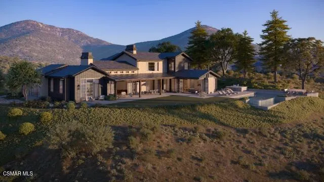 a front view of a house with a garden and lake view