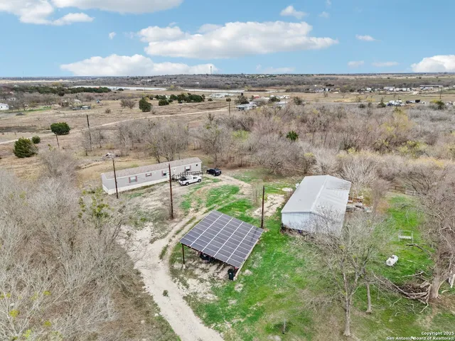 an aerial view of residential houses with outdoor space