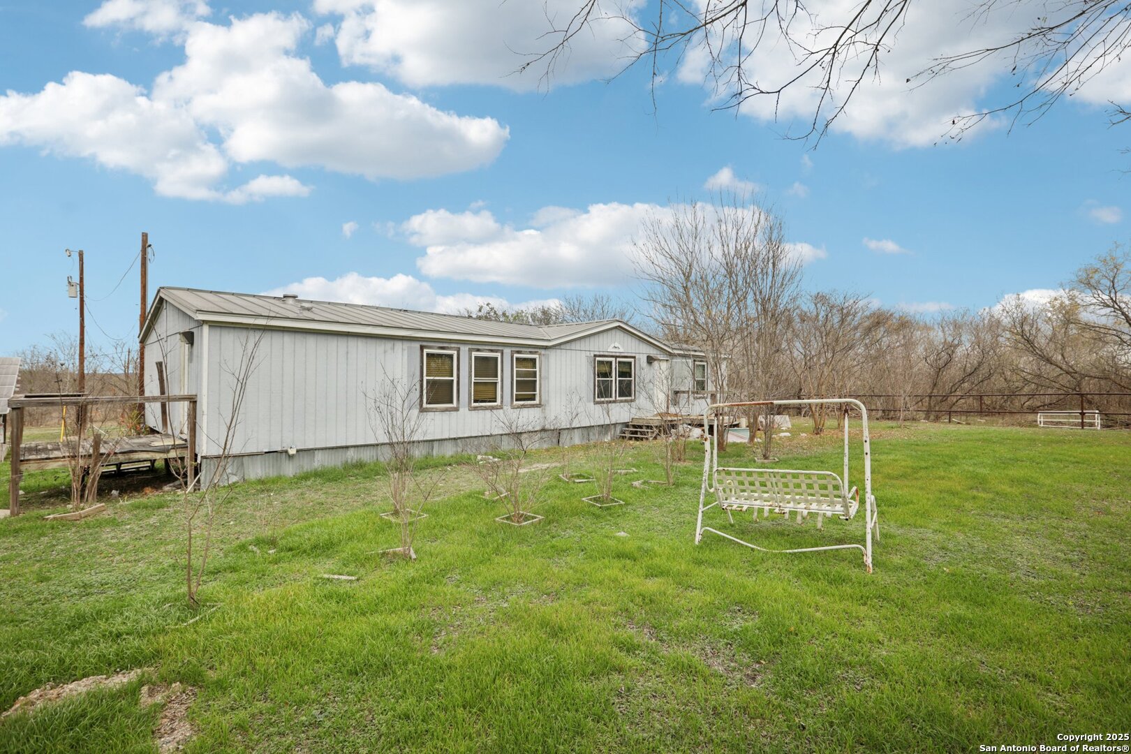 10701 Fm 1625 Austin, TX 78747 - Photo 10 of 43 a white house with a big yard and more large trees