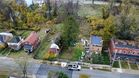 an aerial view of houses with yard