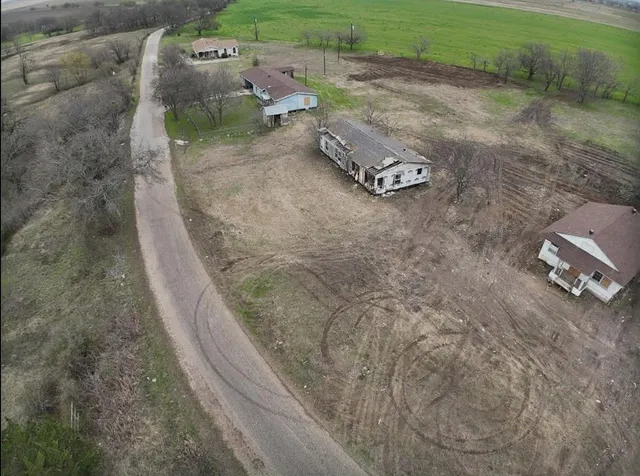 an aerial view of a house with a yard