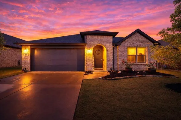 a front view of a house with yard and garage