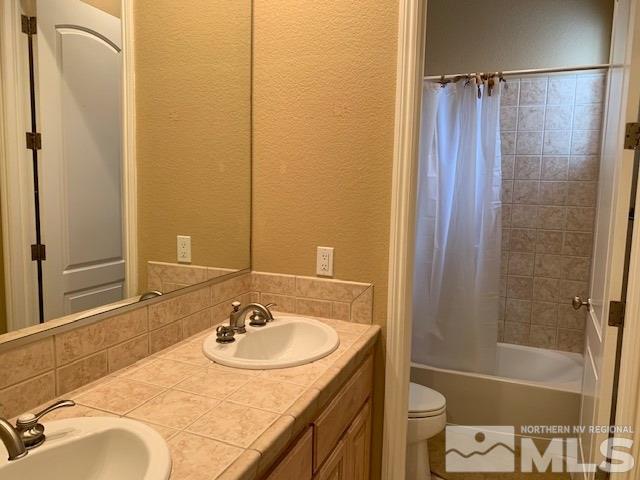 8380 Cinnamon Ridge Lane Reno, NV 89523 - Photo 12 of 17 a bathroom with a sink toilet and shower