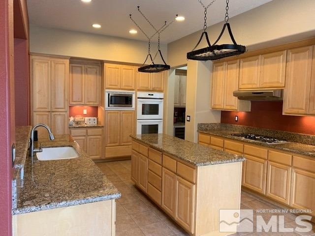 8380 Cinnamon Ridge Lane Reno, NV 89523 - Photo 5 of 17 a kitchen with stainless steel appliances granite countertop a sink stove and refrigerator