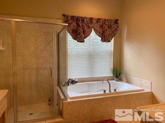 8380 Cinnamon Ridge Lane Reno, NV 89523 - Photo 8 of 17 a bathroom with a bathtub and a shower