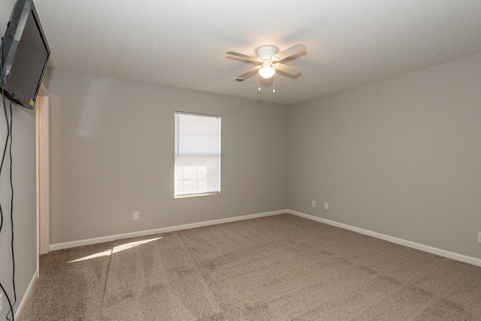 3869 Big Springs Ridge Road Friendsville, TN 37737 - Photo 18 of 21 an empty room with windows and fan