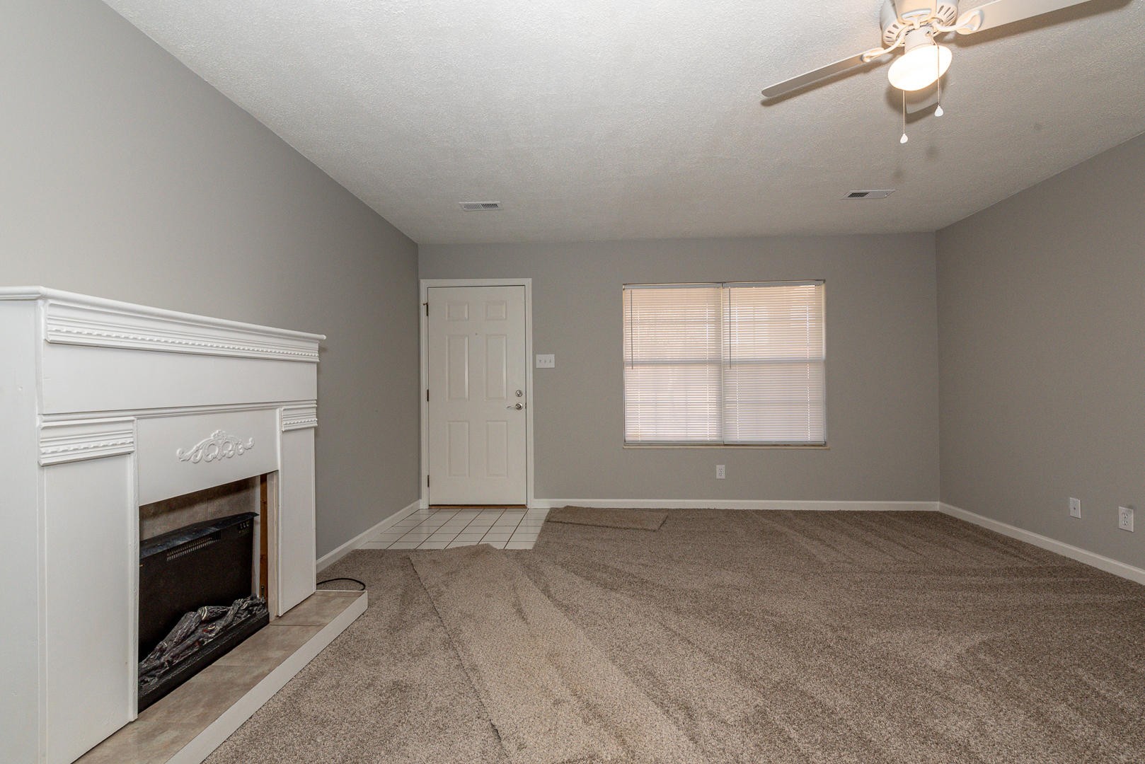 3869 Big Springs Ridge Road Friendsville, TN 37737 - Photo 4 of 21 an empty room with windows and fireplace