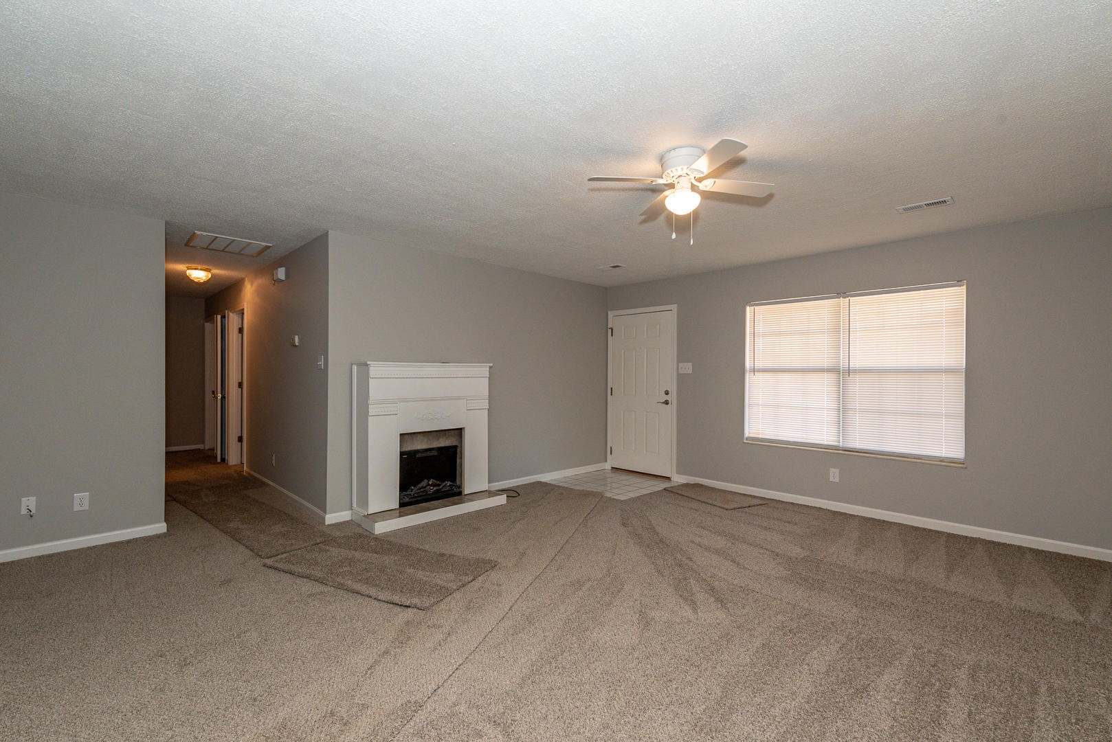 3869 Big Springs Ridge Road Friendsville, TN 37737 - Photo 5 of 21 an empty room with chandelier fan and windows