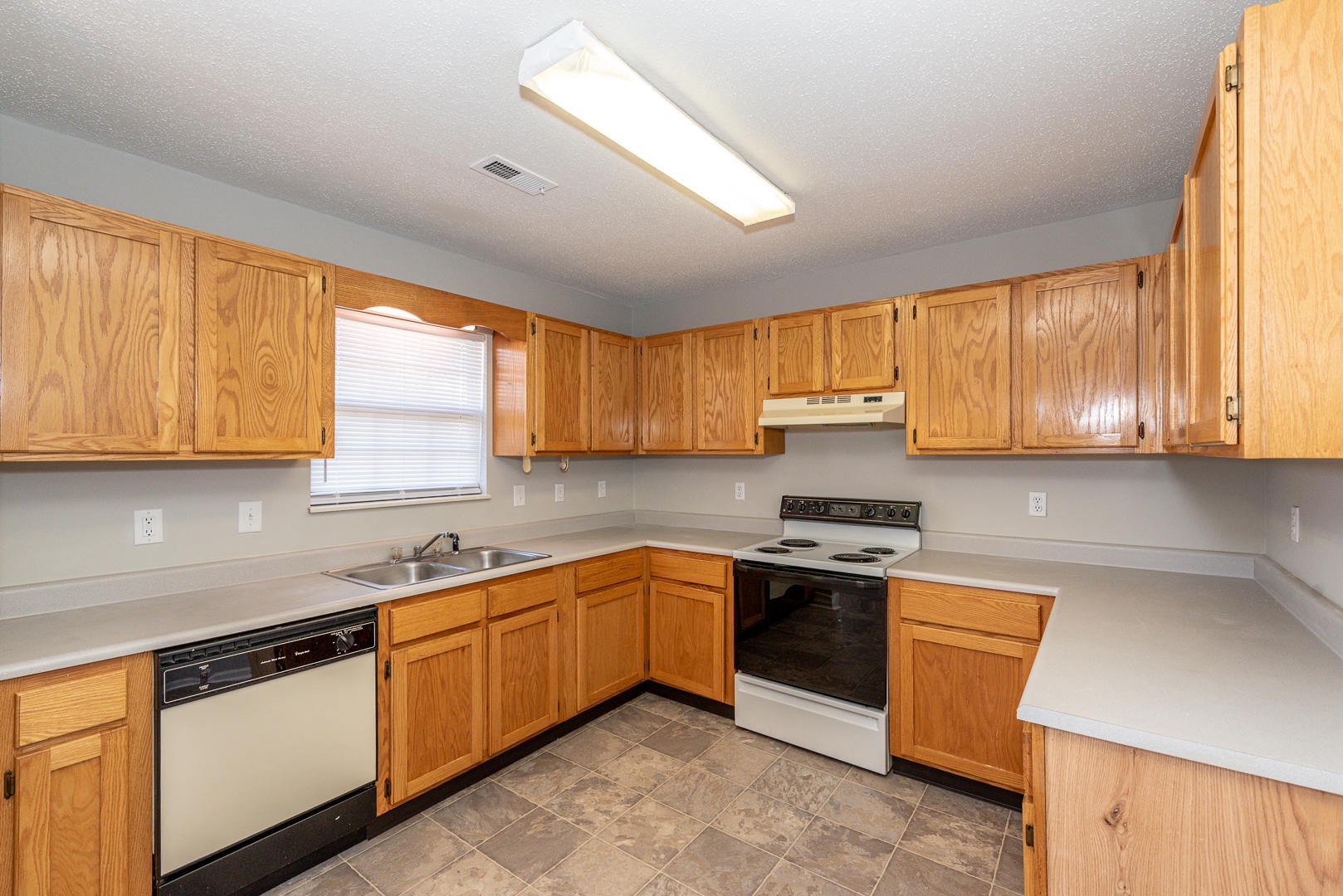 3869 Big Springs Ridge Road Friendsville, TN 37737 - Photo 7 of 21 a kitchen with stainless steel appliances granite countertop a stove a sink dishwasher and a refrigerator