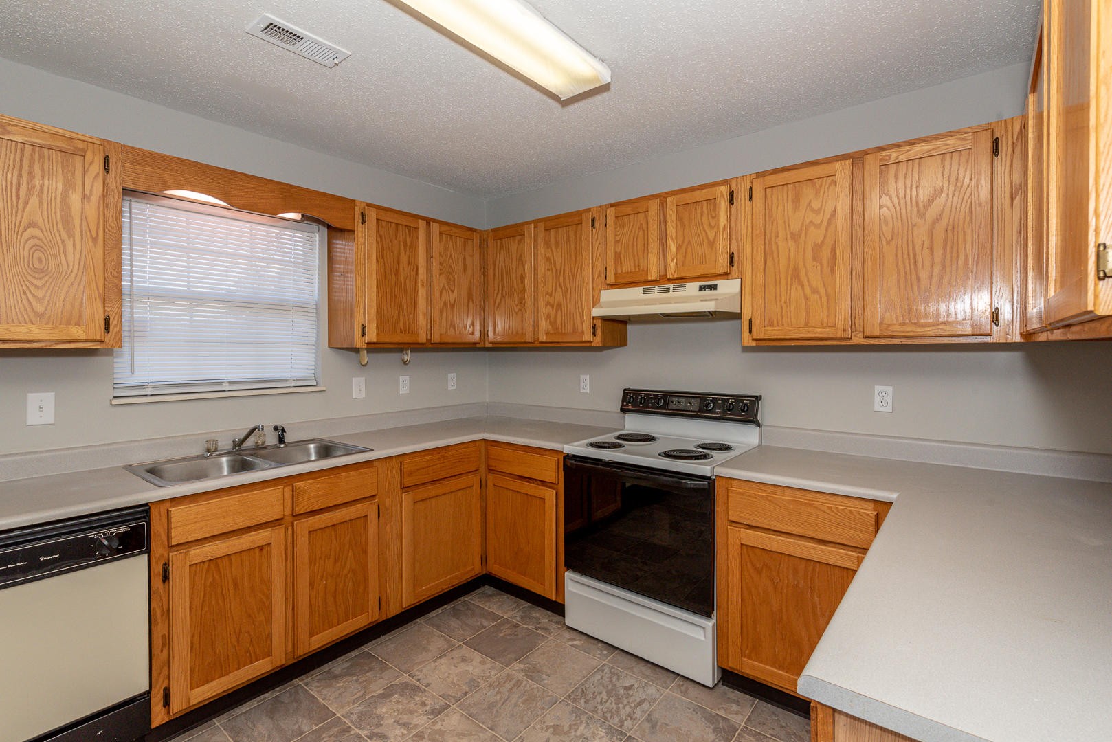 3869 Big Springs Ridge Road Friendsville, TN 37737 - Photo 8 of 21 a kitchen with stainless steel appliances granite countertop wooden cabinets and a stove top oven